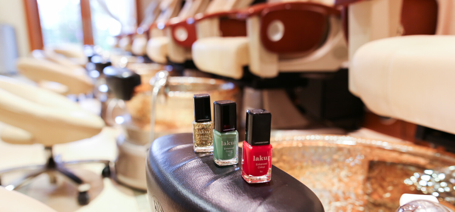 a group of nail polishes on a chair