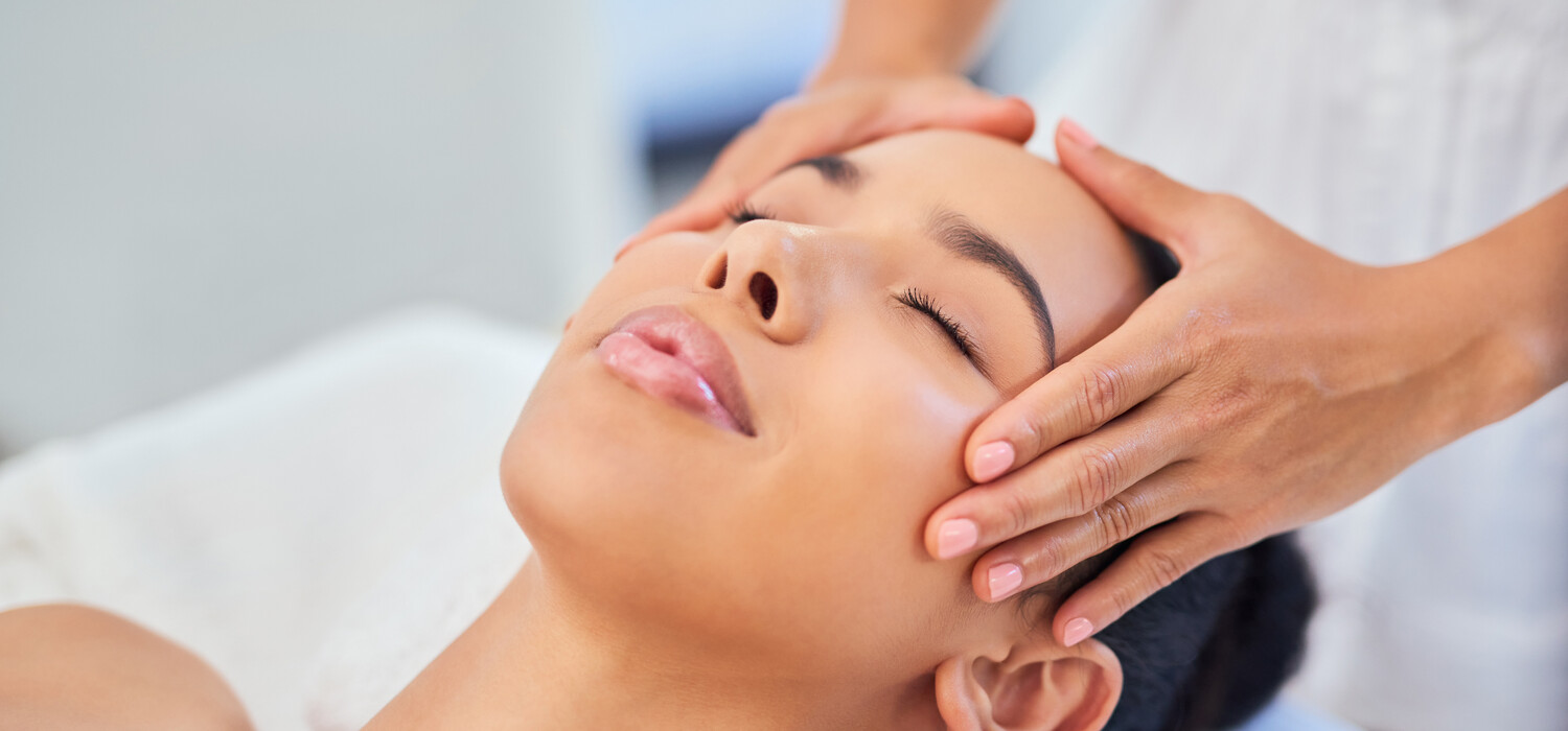 a woman receiving a face massage